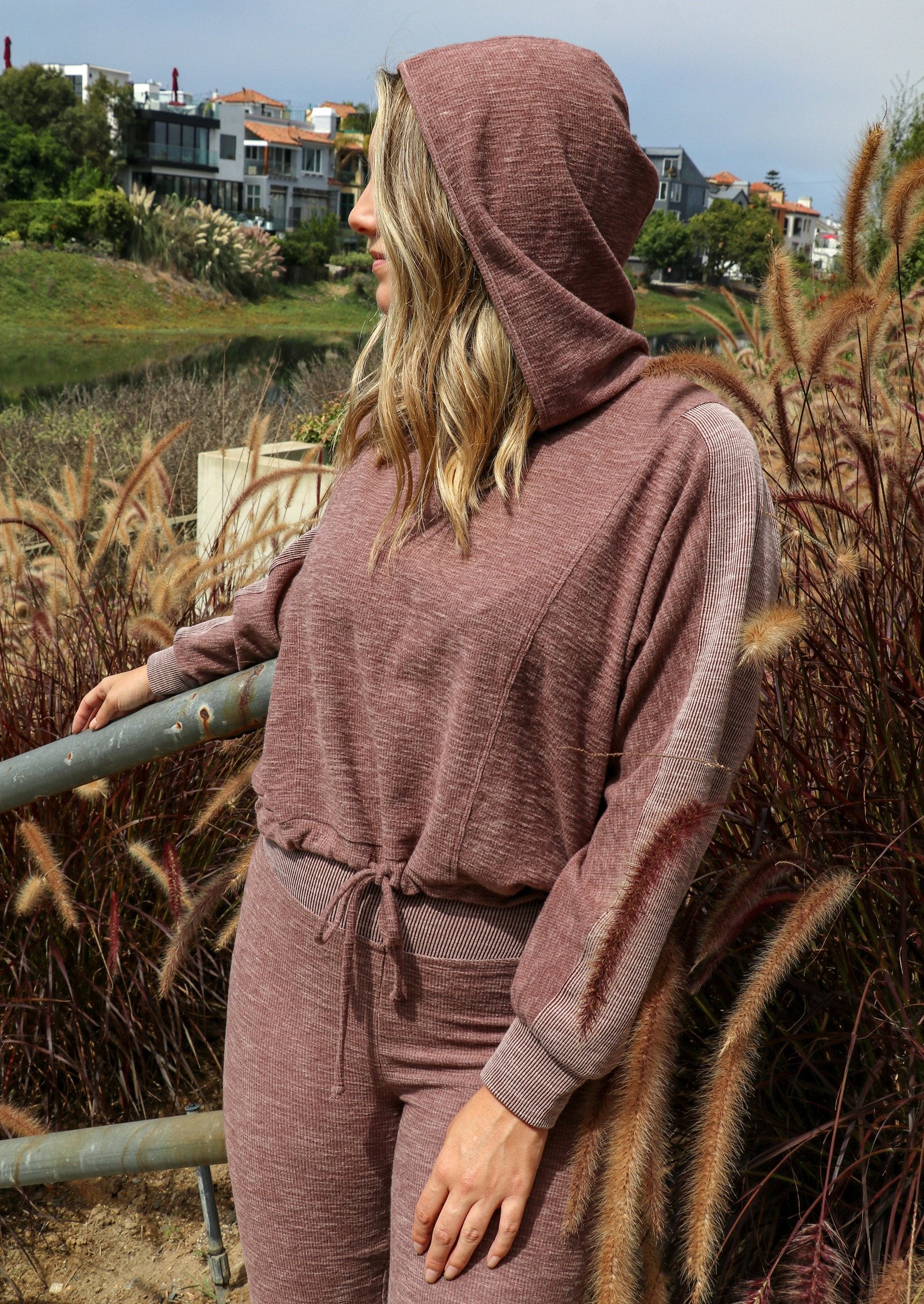 Close-up of Brown Tartarus Morgan Flared Pants in taupe with ribbed fabric detail, styled with a Mabel hoodie and sweatshirt.