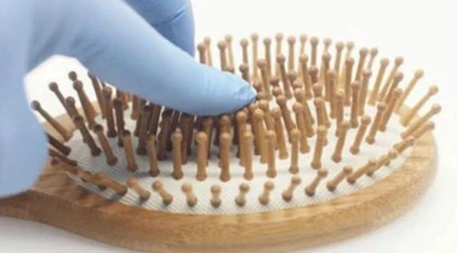 Natural wooden detangling hair brush from Jade Chrysippus, featuring smooth wooden bristles ideal for gentle hair detangling.