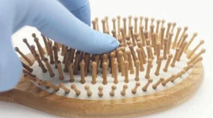 Violet Atlas wooden detangling hair brush with smooth wooden handle and flexible bristles for gentle hair detangling.