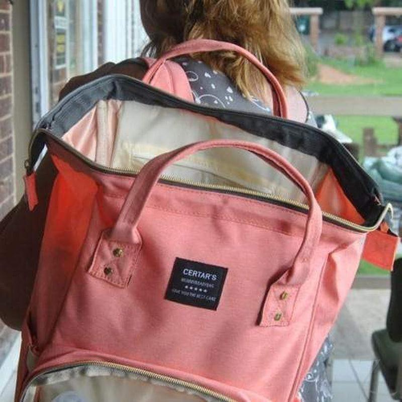 Raspberry Pallas peach jeans backpack baby bag with adjustable straps and multiple compartments, suitable for carrying baby essentials.