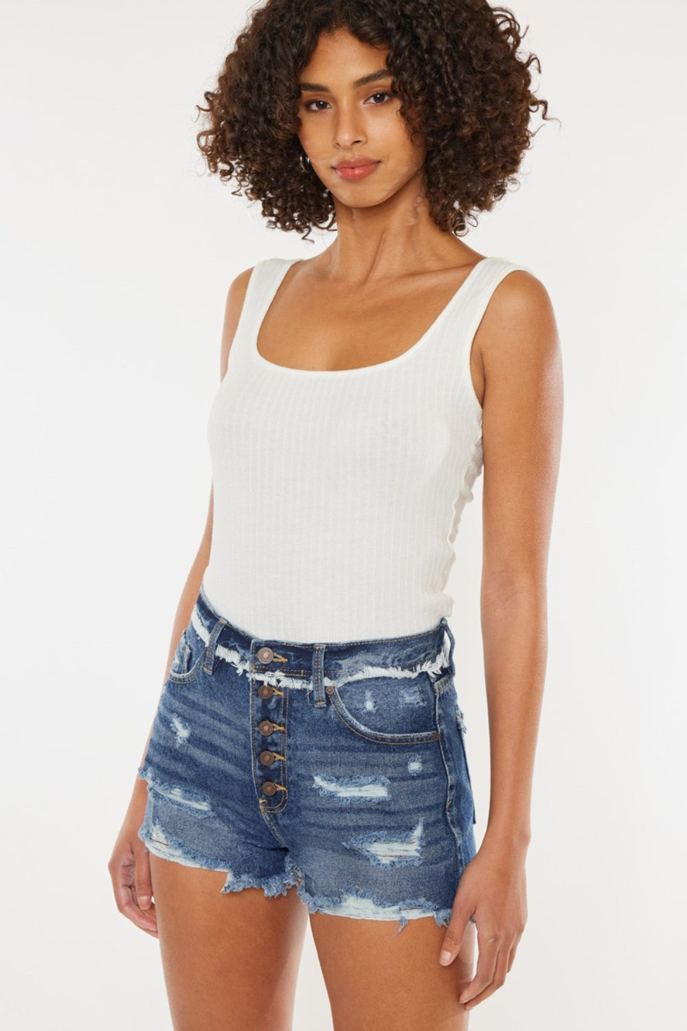 Jade Icarus Kancan distressed button fly denim shorts for women, showing frayed edges and high-waisted fit on model.