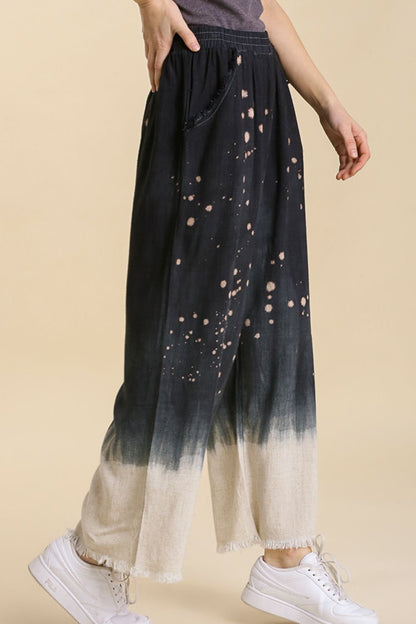 Jade Icarus Umgee linen blend wide-leg pants with raw hem and bleach dip dye, displayed on a mannequin.