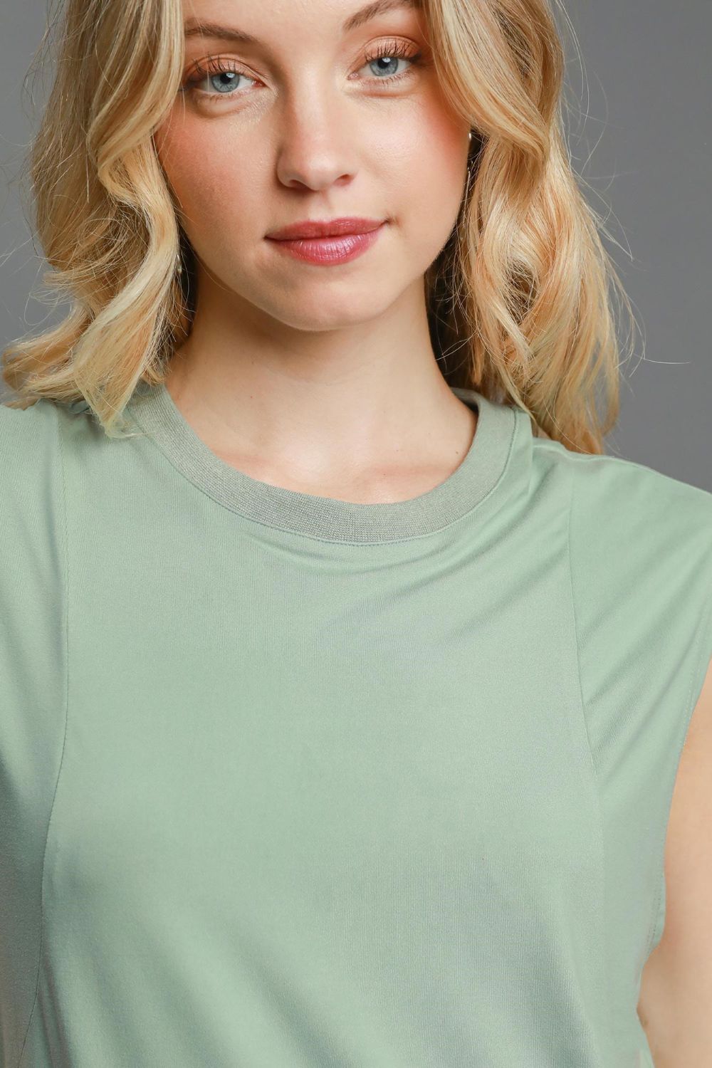 Jade Icarus sleeveless mini dress with round neckline, high-low hemline, in a curved design, featuring a stylish automotive-inspired look.