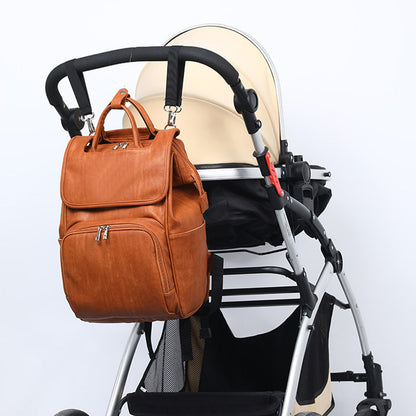 Maroon Asteria PU leather diaper bag with multiple compartments, designed for moms and baby essentials, in a stylish maternity bag.