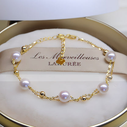 18k gold seawater pearl adjustable double-layer bracelet by Carmine Juneberry featuring elegant pearls and layered design.