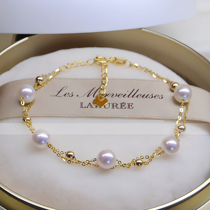 18k Gold Seawater Pearl adjustable double-layer bracelet by Carmine Juneberry, featuring elegant pearls and delicate design.