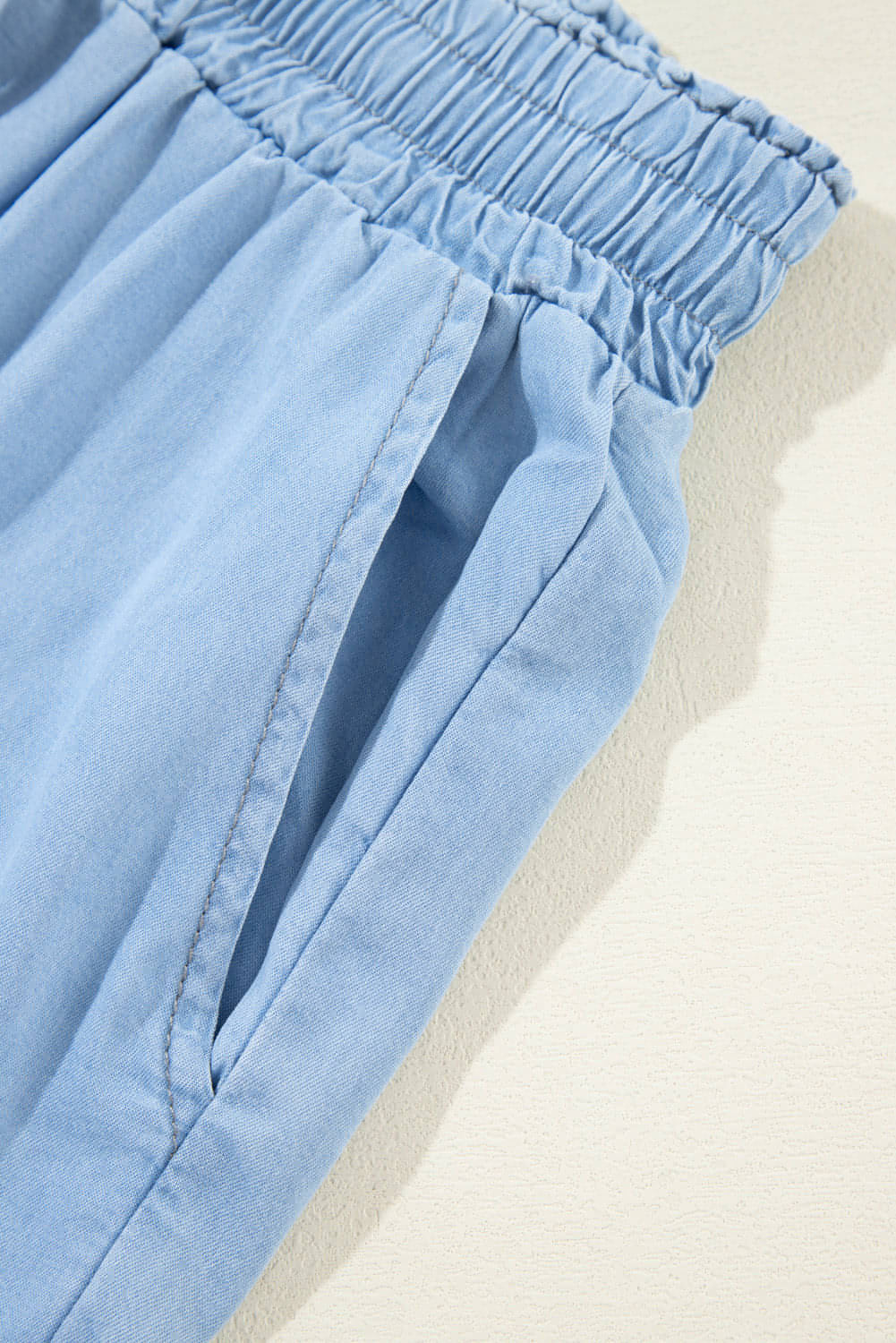Carmine Juneberry Myosotis high waist drawstring wide leg denim pants with relaxed fit and classic blue jean wash.