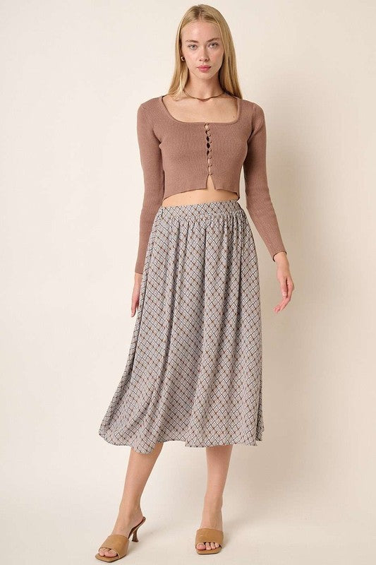 Jade Icarus Mittoshop printed midi skirt with automotive-inspired design, featuring a colorful pattern and flowing fabric.