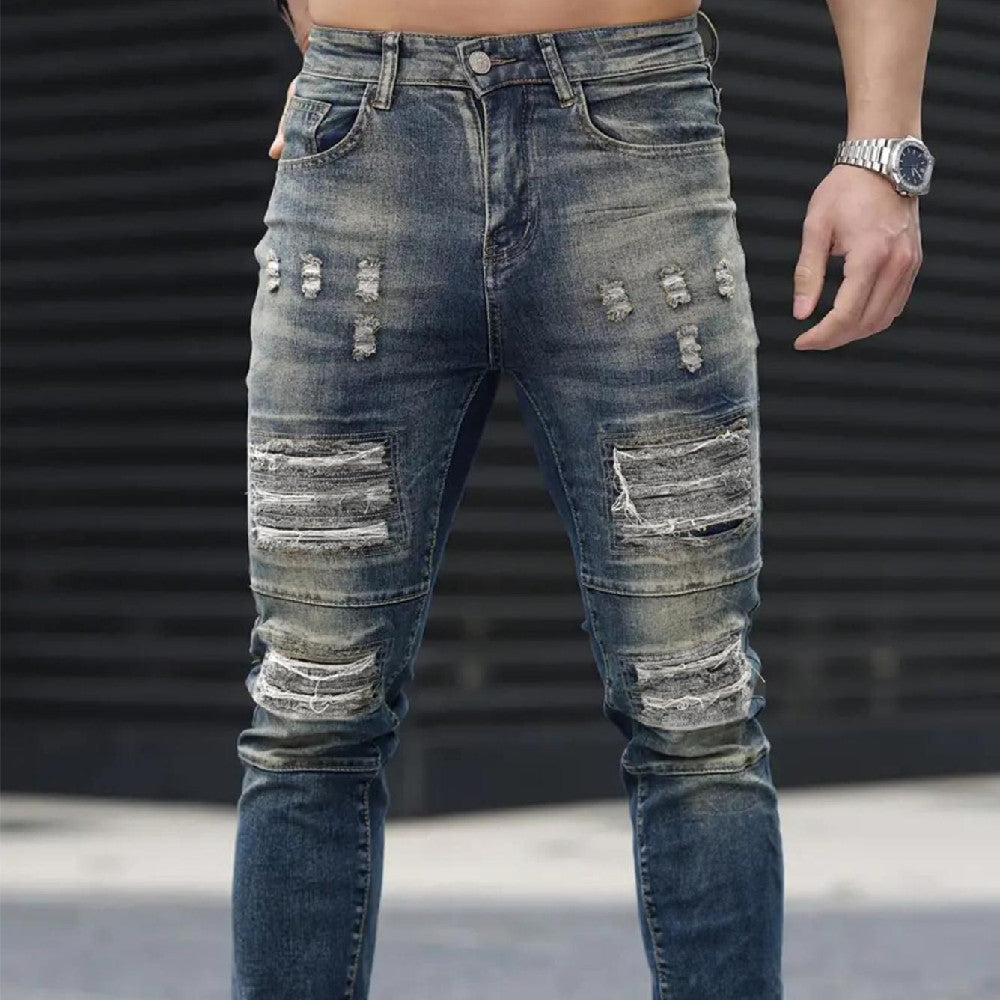 Men’s navy ripped stretch jeans by Carmine Juneberry, high street urban style with distressed details and slim fit.