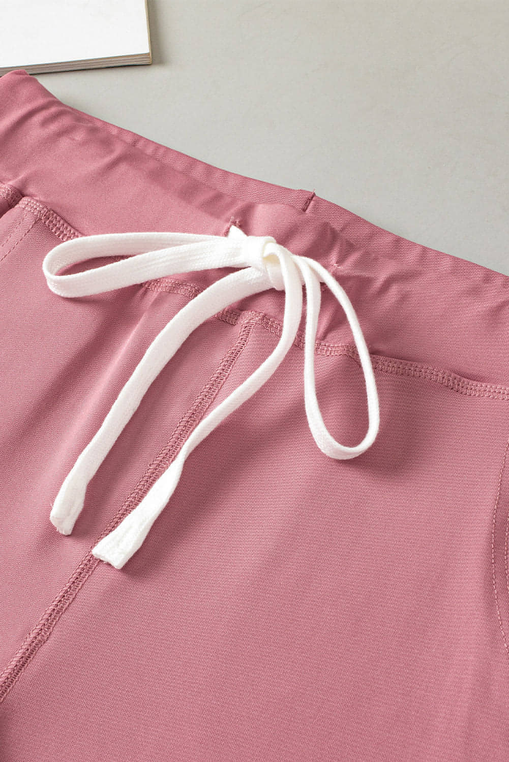 Pink drawstring waist joggers with pockets from Carmine Juneberry activewear, comfortable and stylish for workouts or casual wear.