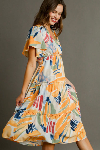 Colorful abstract print Umgee flutter sleeve tiered midi dress by Jade Icarus, featuring frill details and a flowing silhouette.