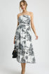 Colorful printed Umgee tiered tube midi dress from Pear Daisy, displayed on a hanger with floral background.
