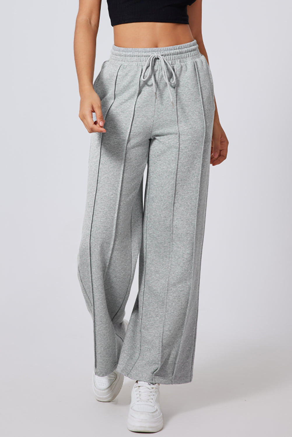 Gray seamed drawstring high waist wide-leg sweatpants by Carmine Juneberry, showing the relaxed fit and comfortable waistband.