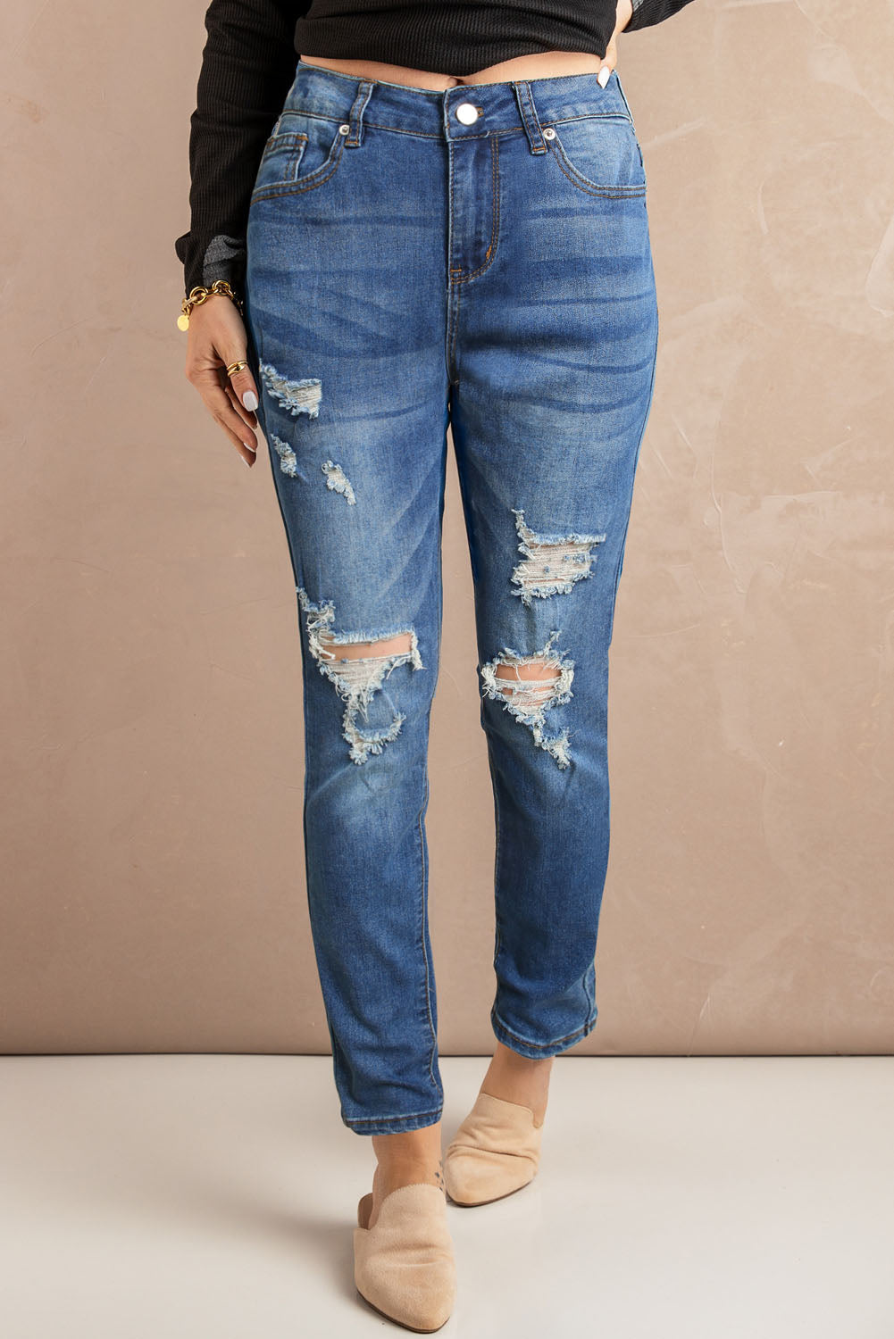 Blue hollow-out vintage skinny ripped jeans by Harlequin Daisy, showcasing distressed denim with ripped details and a slim fit style.