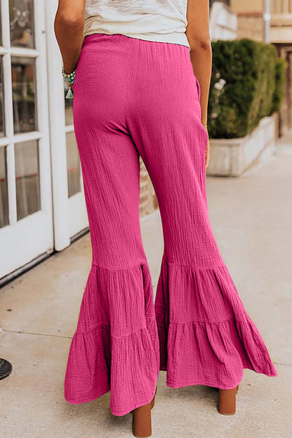 Rose textured high waist ruffled bell bottom pants by Carmine Juneberry displayed on a model.