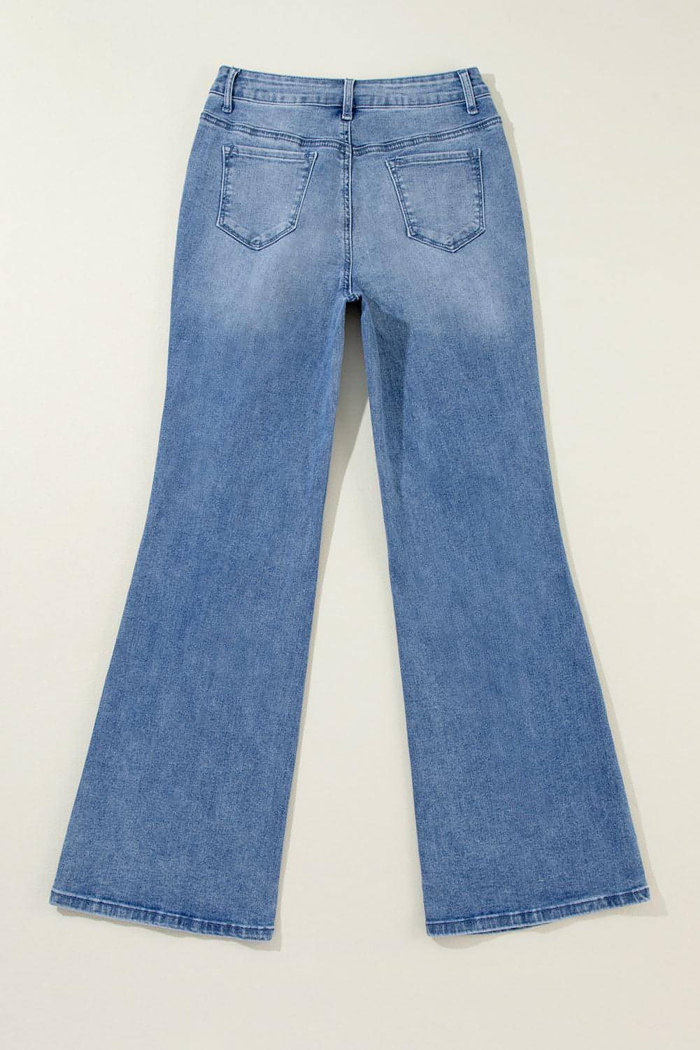 Blue acid wash distressed wide-leg high waist jeans by Carmine Juneberry, showcasing the relaxed fit and stylish design.
