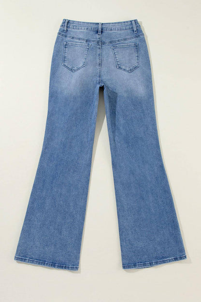 Blue acid wash distressed wide-leg high waist jeans by Carmine Juneberry, showcasing the relaxed fit and stylish design.