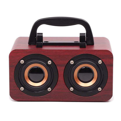 Maroon Asteria portable wooden Bluetooth speaker for outdoor use, compact design with built-in controls and natural wood finish.
