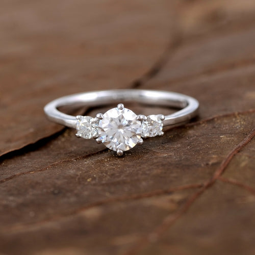 Sterling silver white moissanite 3-stone ring featuring sparkling gemstones and elegant design.
