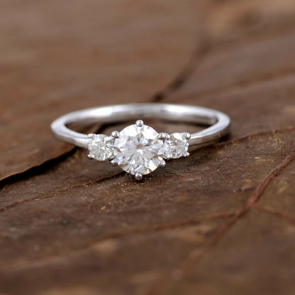 Sterling silver white moissanite 3-stone ring featuring sparkling gemstones and elegant design.