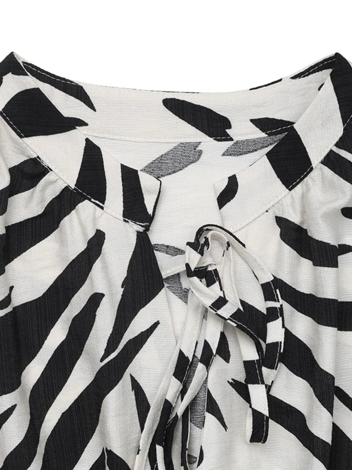 Printed notched sleeveless midi dress for women by Ruby Styx, shown in a stylish, flowy design with a vibrant print.