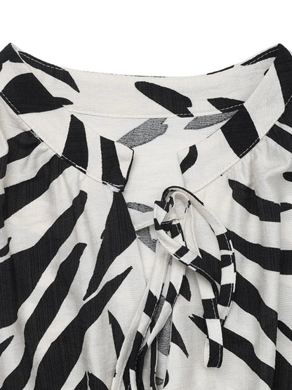 Printed notched sleeveless midi dress for women by Ruby Styx, shown in a stylish, flowy design with a vibrant print.
