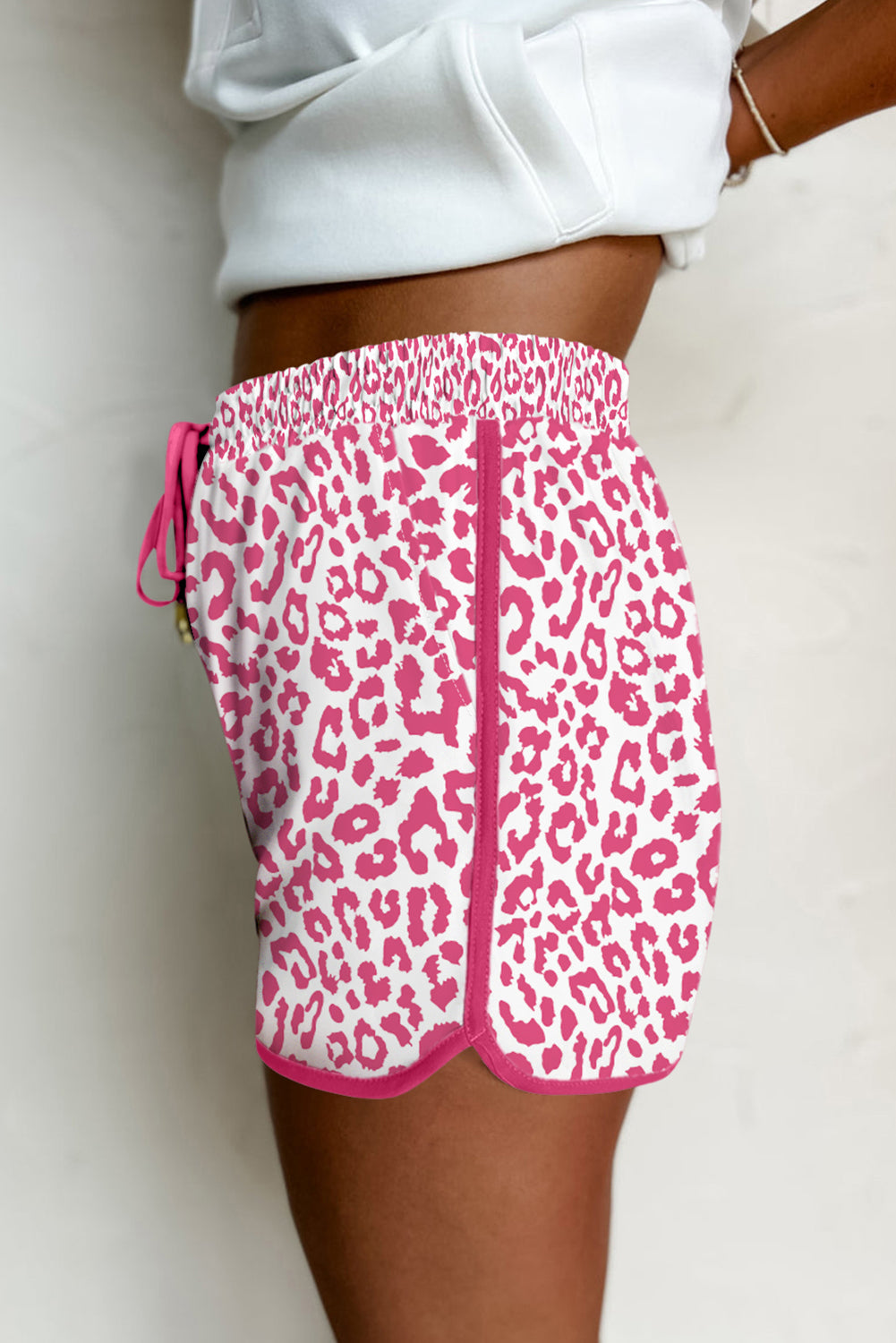 Pink leopard print casual shorts with elastic waistband, lace-up front, contrast trim, designed for women by Ruby Styx.