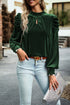 Blackish green velvet mock neck blouse with puff sleeves by Carmine Juneberry, shown on a hanger.