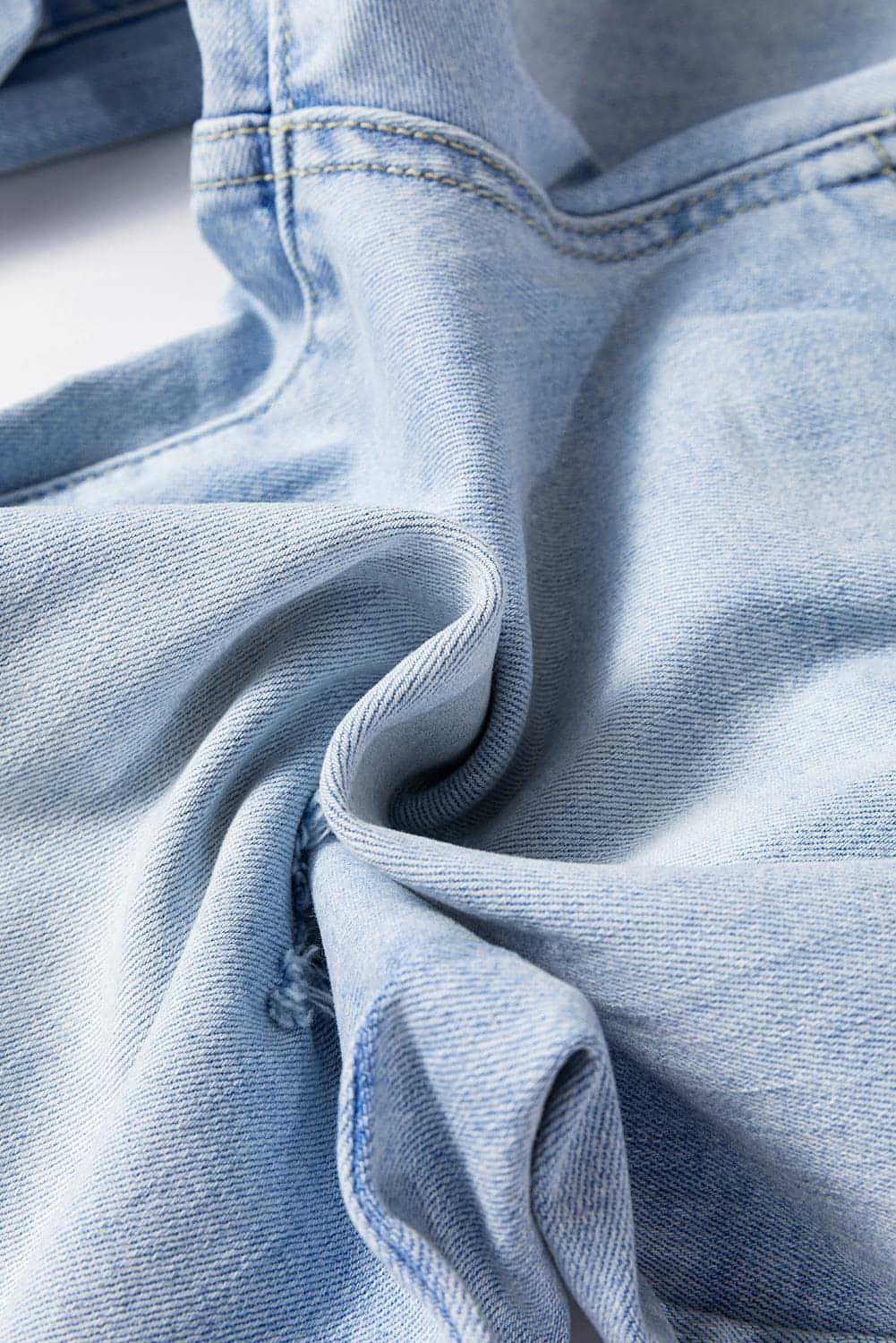 Carmine Juneberry Beau Blue vintage light wash distressed flare jeans with frayed hem and distressed details.
