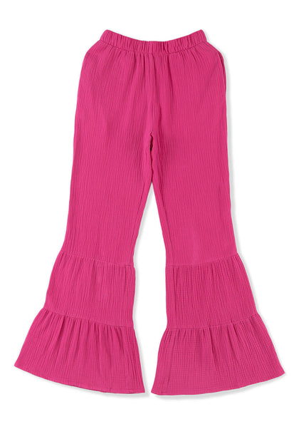 Rose textured high waist ruffled bell bottom pants by Carmine Juneberry, showing the detailed ruffle and bell shape design.