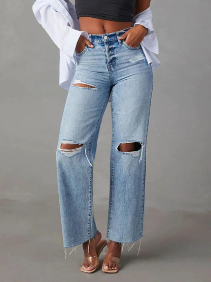 Pair of Pear Daisy distressed straight leg jeans with pockets, showcasing a casual, worn-in denim look.