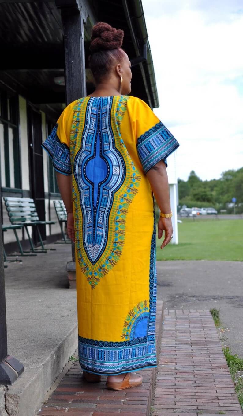 White Baobab African Dashiki dress, long kaftan-style T-shirt with vibrant traditional African patterns and colorful embroidery.
