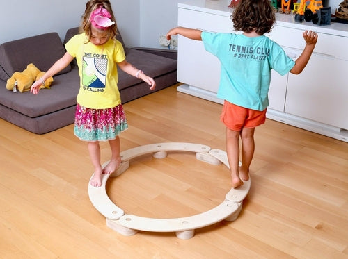 Circular wooden balance beam set by Red Oceanus, featuring colorful children&