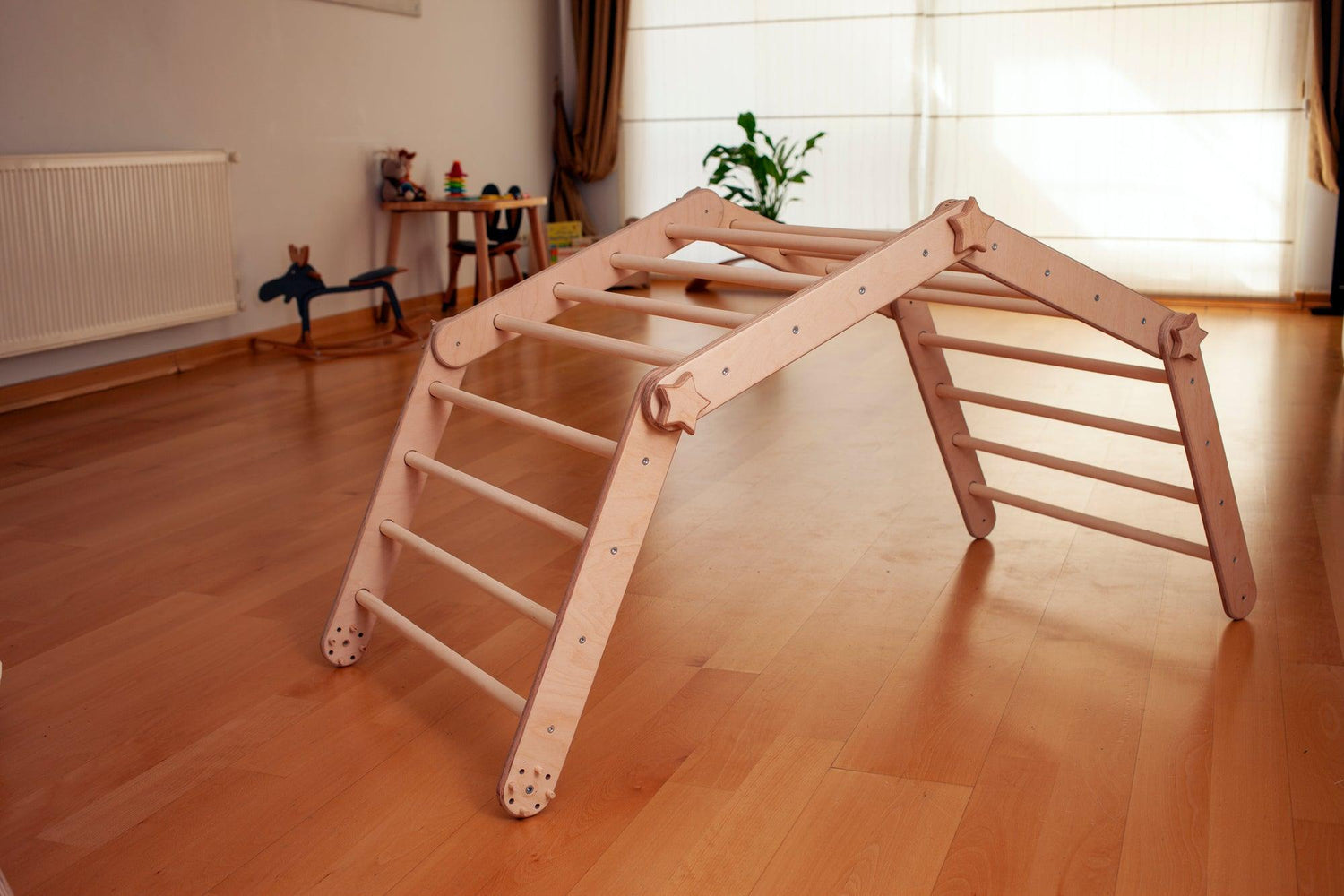 Red Oceanus transformable climbing cube with ramp, versatile furniture piece for climbing and play in a modern home setting.