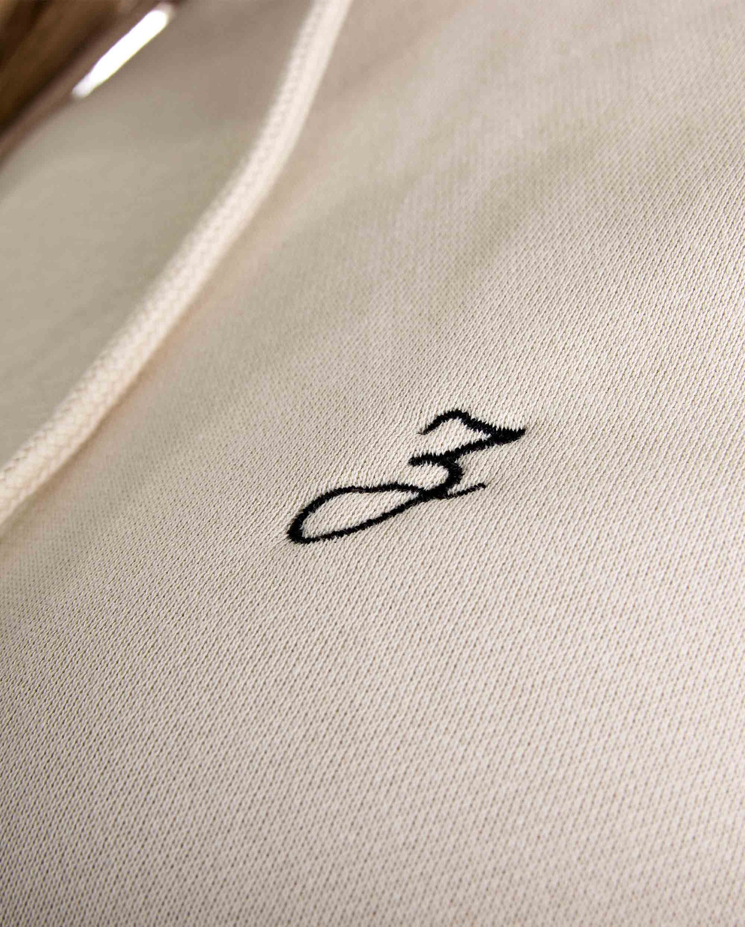 Close-up of Pear Juniper HIGH STD hoodie in sand color, showcasing the soft fabric and stylish hood design for women&
