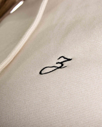 Close-up of Pear Juniper HIGH STD hoodie in sand color, showcasing the soft fabric and stylish hood design for women&