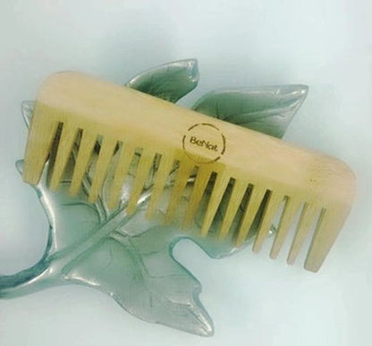 All-natural bamboo hair comb from Violet Atlas, featuring smooth teeth and eco-friendly design for gentle hair detangling.