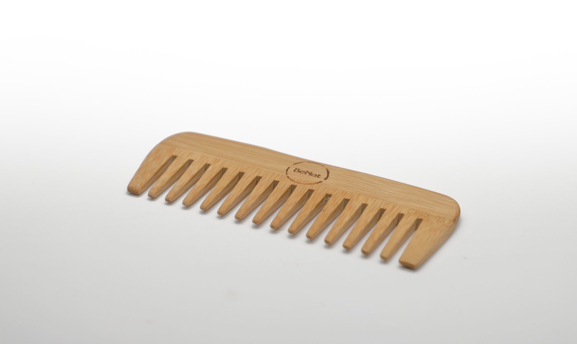 All-natural bamboo hair comb from Violet Atlas, showcasing smooth, eco-friendly teeth for gentle hair detangling.