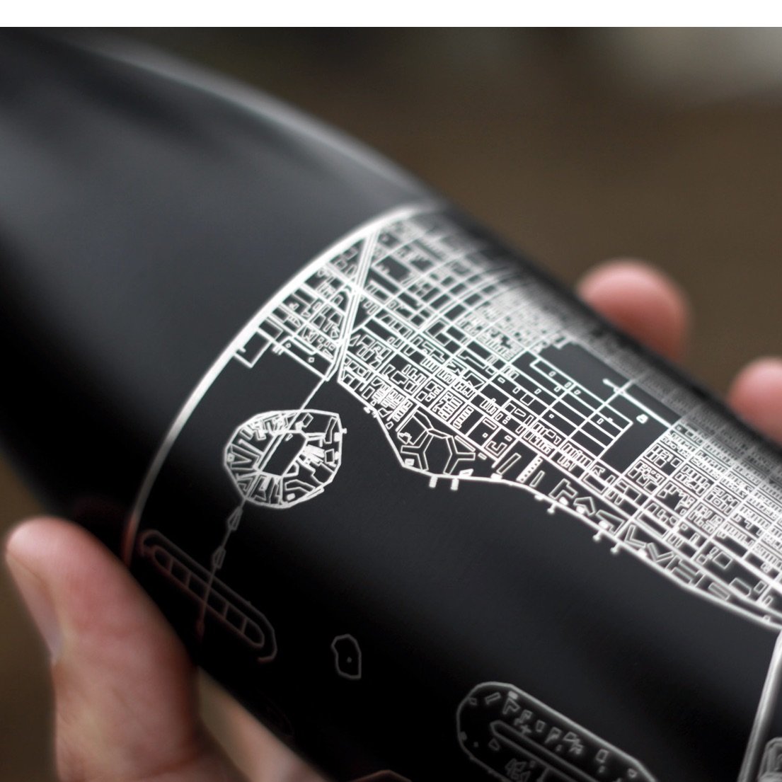 Cyan Castor Cormorant Lake Manitoba insulated bottle in matte black with a detailed lake map design.