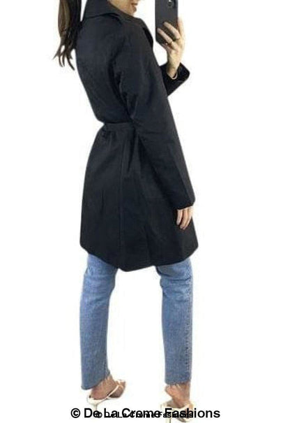 Rose Eleusis cotton blend belted trench coat with classic collar, button closure, and waist belt on a hanger.