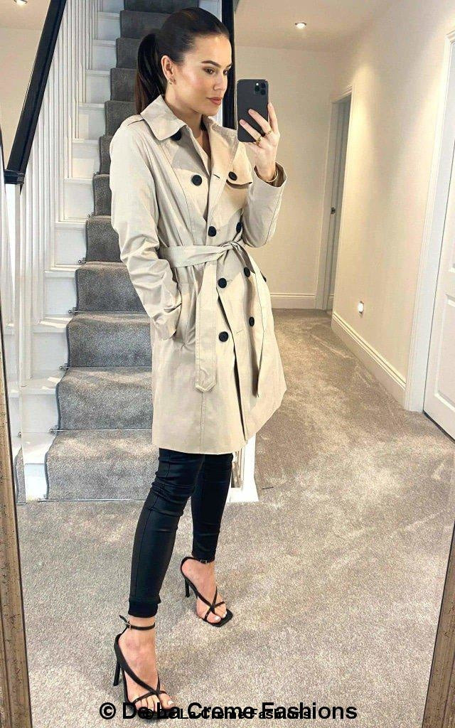 Rose Eleusis cotton blend belted trench coat hanging on a wooden hanger, showcasing classic collar and waist belt detail.
