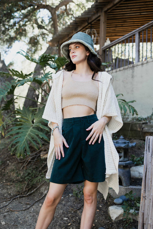 Soft ivory waffle hooded ruana by Periwinkle Aether, cozy accessories with a relaxed fit and stylish hood for comfort.