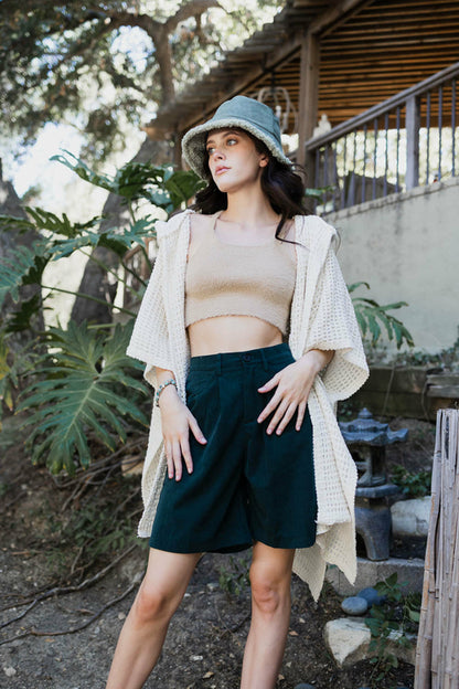 Soft ivory waffle hooded ruana by Periwinkle Aether, cozy accessories with a relaxed fit and stylish hood for comfort.