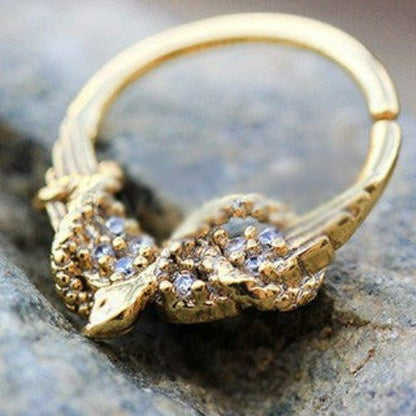 Gold plated jeweled wings and snake seamless ring, stylish septum jewelry by Peridot, featuring intricate design and sparkling accents.