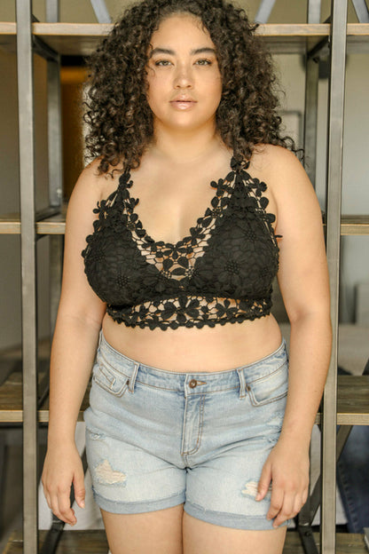 Black crochet daisy longline bralette by Periwinkle Aether, showcasing intricate crochet detailing and a delicate floral design.