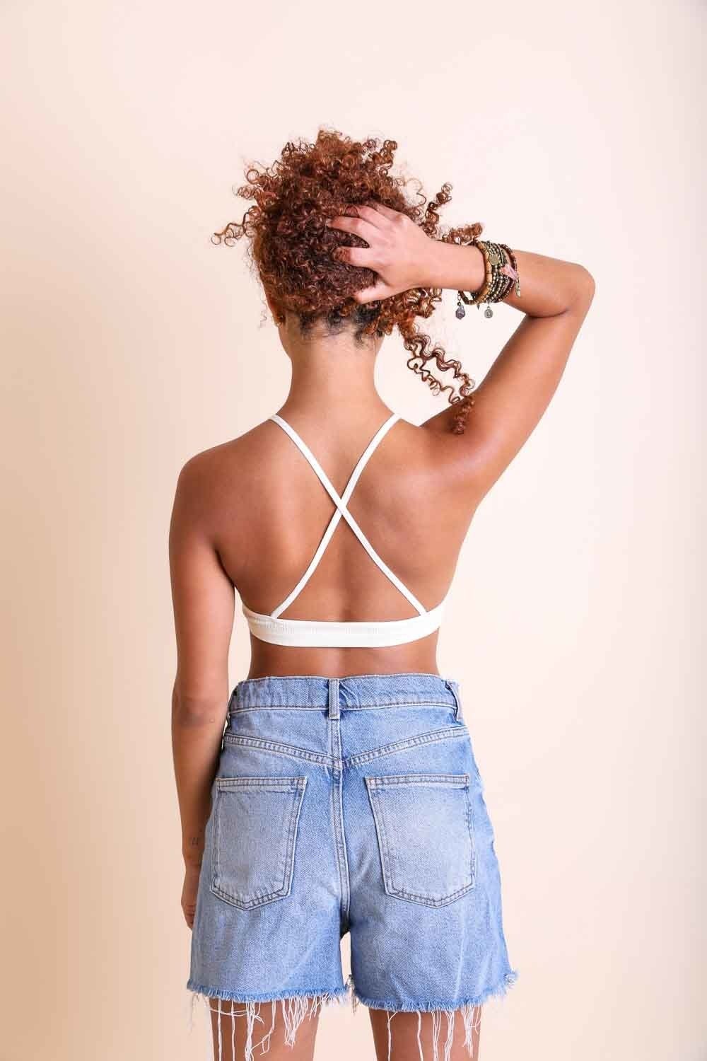 Periwinkle Aether crochet lace high-neck bralette with halter style and cross-back design, showcasing delicate lace details.