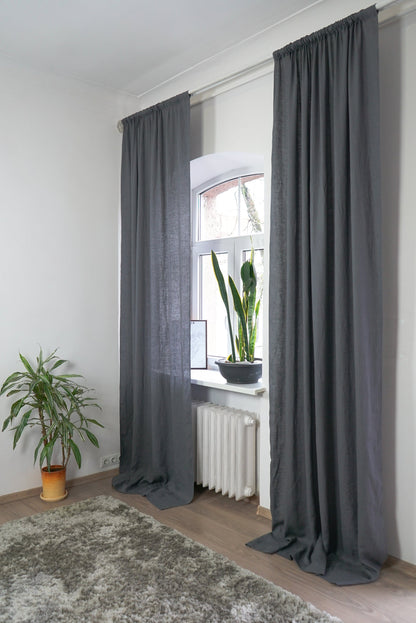 Grey linen curtain with rod pocket by Magenta Sugarplum hanging on a window, showcasing elegant home decor.