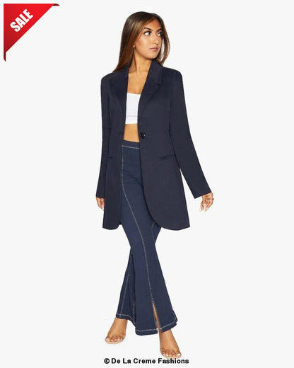 Navy blue Rose Eleusis curved hem longline blazer displayed on a hanger, showcasing its tailored fit and elegant design.