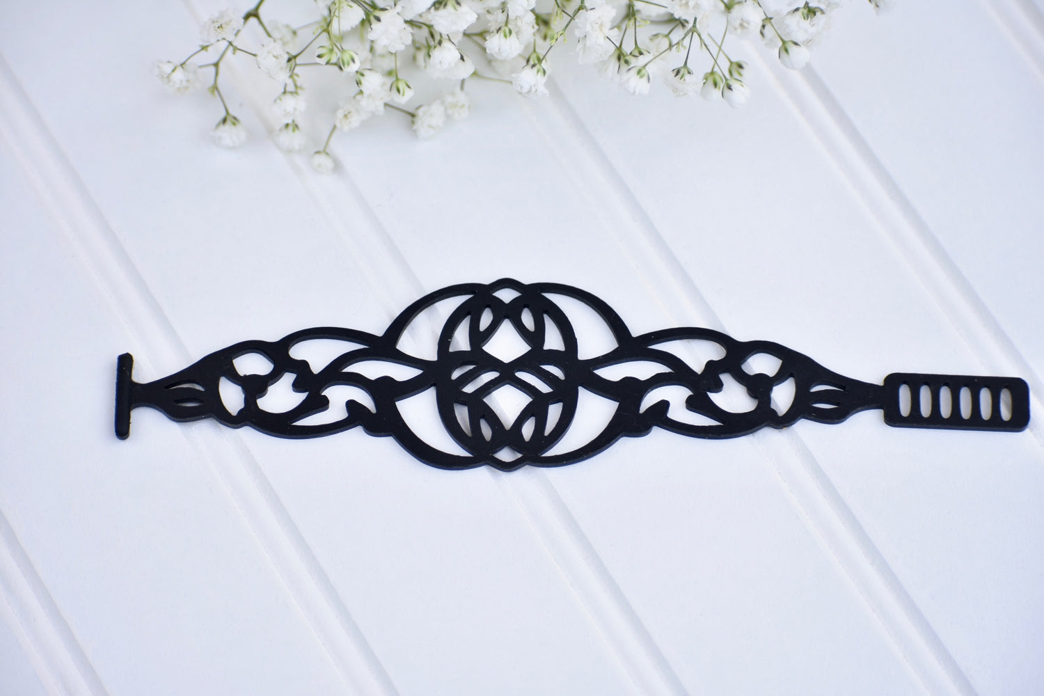 Black Rose Brave Bracelet, stylish jewelry piece featuring a sleek design with intricate details in silver-tone metal.