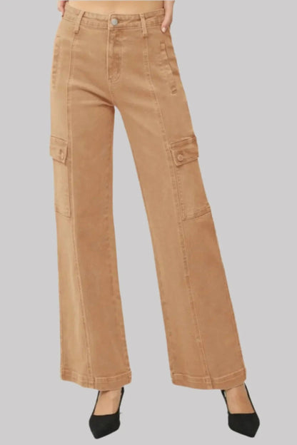 Pear Daisy RISEN full size high rise wide leg cargo jeans hanging on a clothing rack, showcasing their relaxed fit and stylish design.